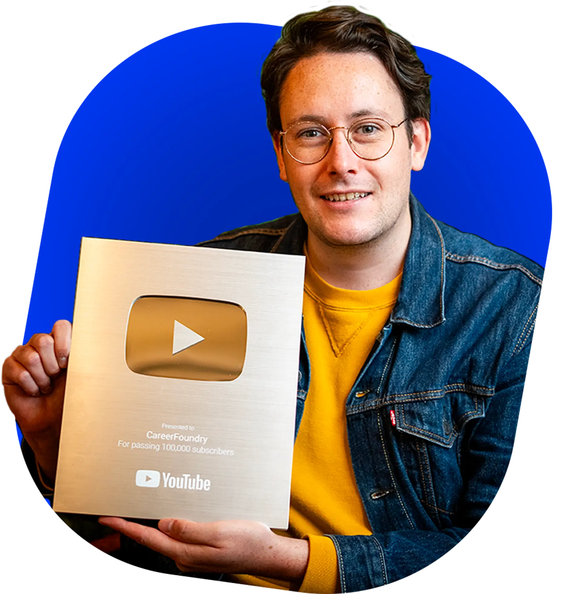 Calum Russell holding a YouTube Silver Play button Award on a blue background shape.